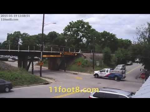 Dumpster truck’s tarp cover hits 11foot8 bridge