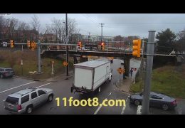 Pedestrian dodges truck crash debris at the 11foot8 bridge
